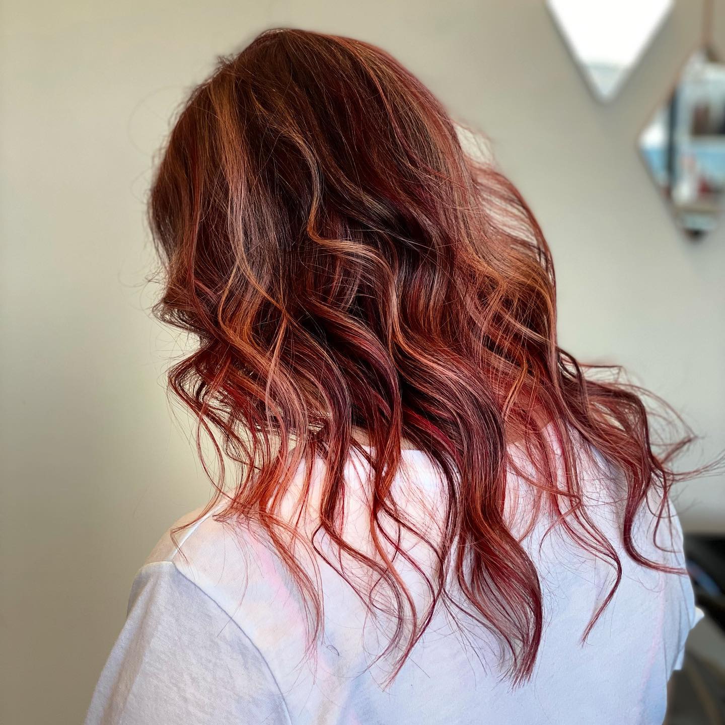 Glossy copper-red shoulder-length waves.