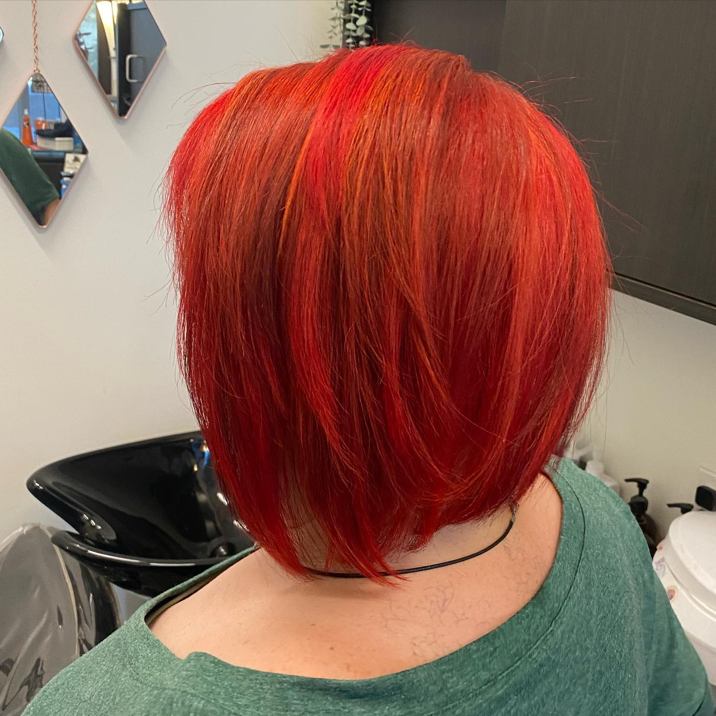Sleek vivid red bob viewed from the back.