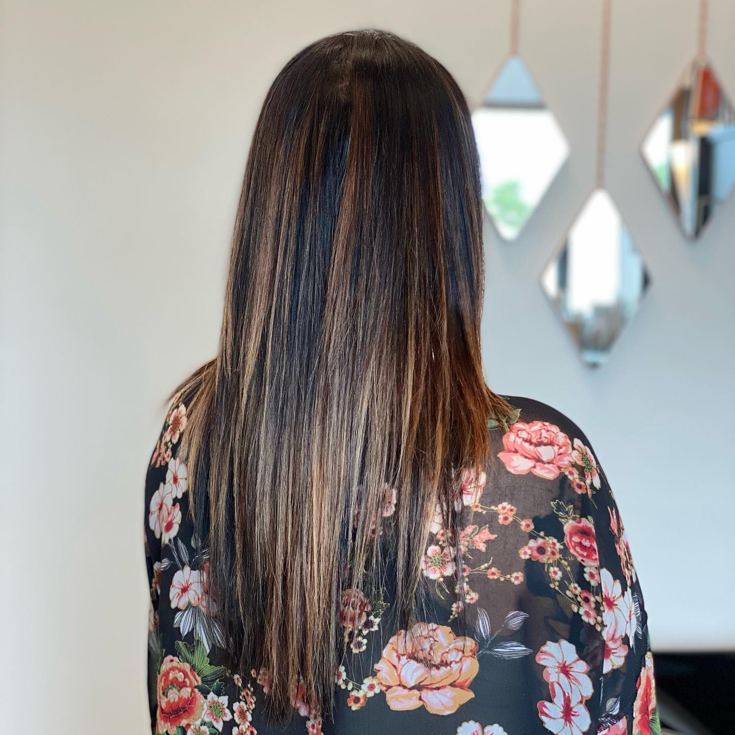 Long straight brunette hair with warm brown dimension.