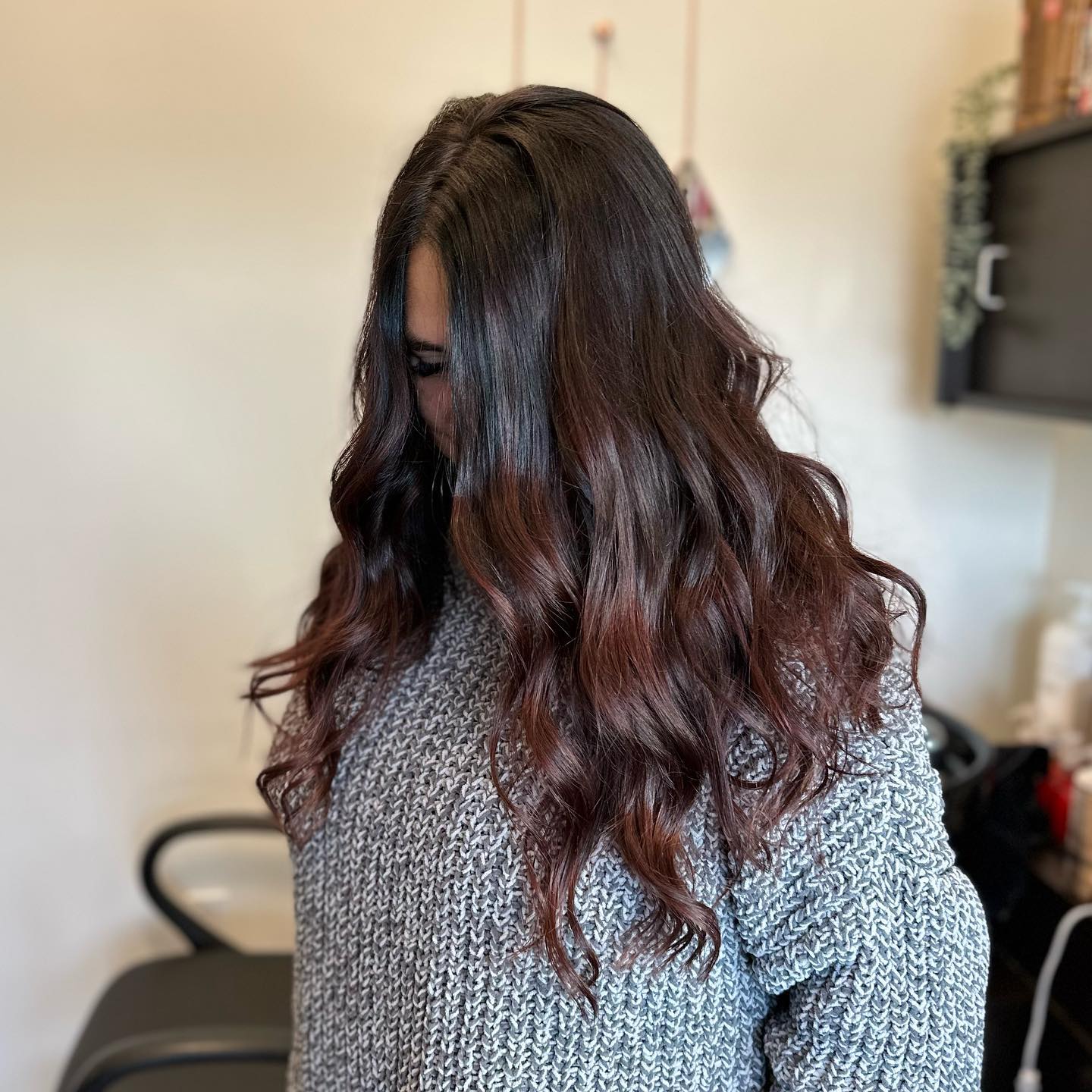 Long brunette waves with subtle warm copper ribbons.